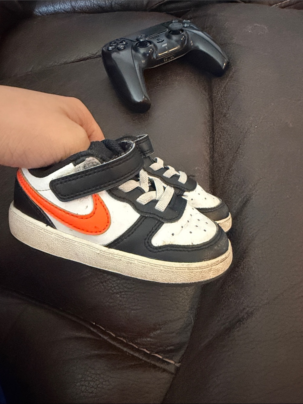 Nike Kids Black and White Sneakers with Orange Swoosh